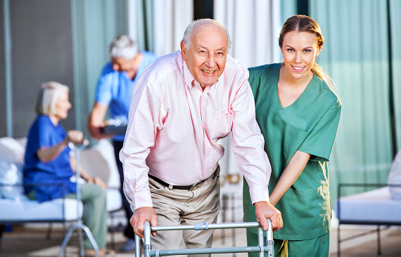 female caregiver assisting senior man
